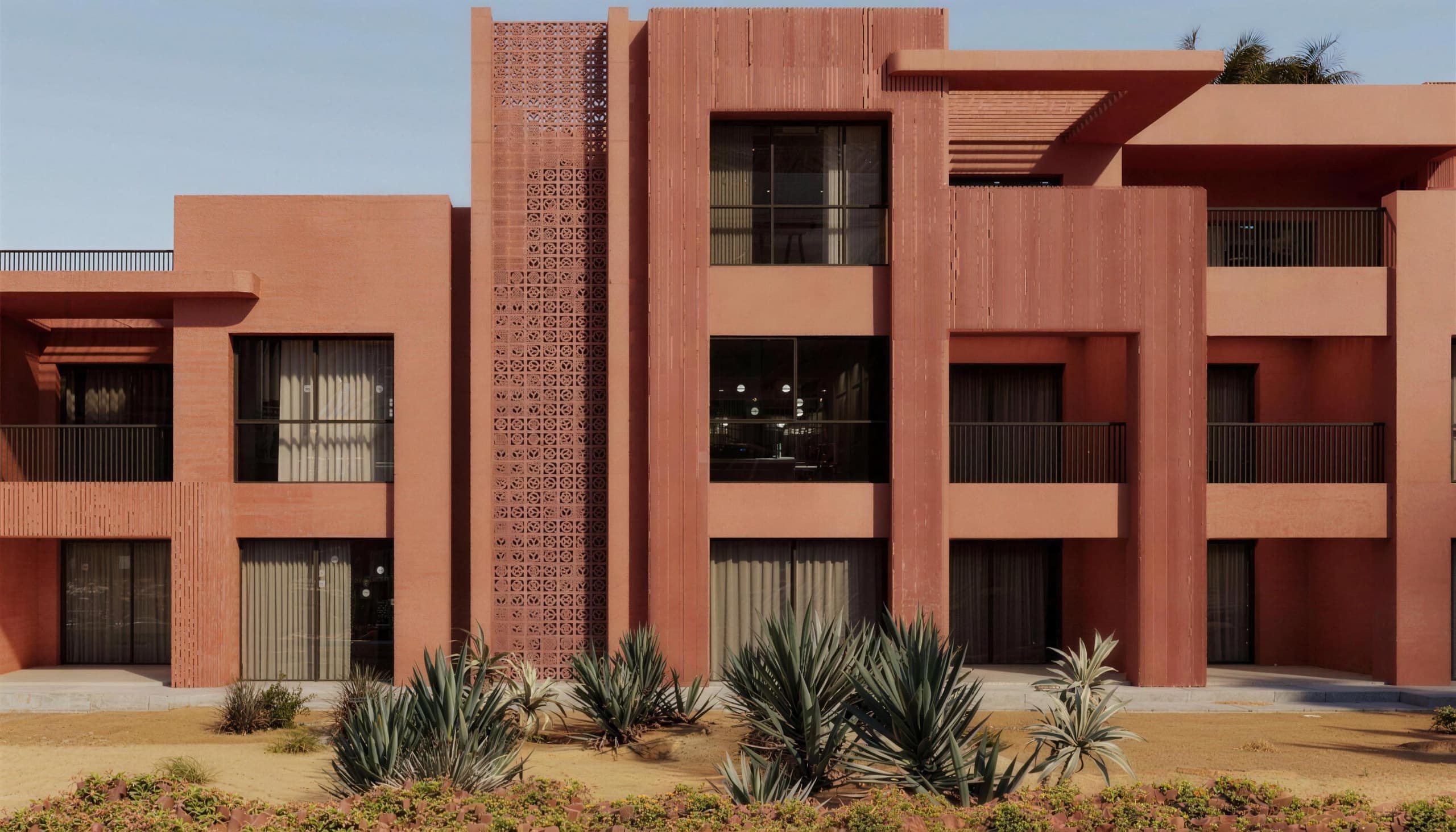 Coral Apartments B6 — elevation showing deep balconies, external stairs and screen-block panels